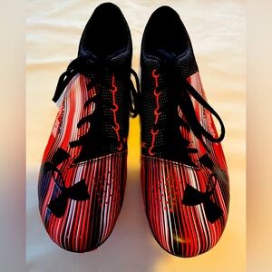 Under Armour racing sprinter spikes.  Included neon Nike bag.